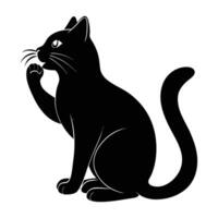 Gentle cat licking its paw in a calm silhouette display vector