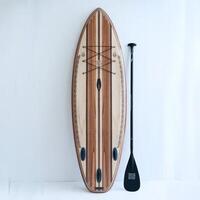 A paddle board and paddle with a wooden stand up paddle board photo