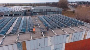 Powerful station with solar panels. Aerial shot of worker installing and working on maintenance of photovoltaic panel system video