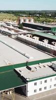 Aerial view of the woodworking factory outside the city. Camera motion to backwards Vertical video