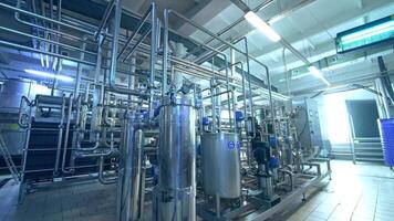 Inside the milk products factory. Complicated system of pipelines, cisterns and tubes and sensors at the dairy manufacturing plant. video