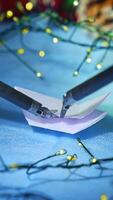 Artificial intelligence robot preparing snowflake from paper while preparing to the Christmas. Cropped view. Vertical video
