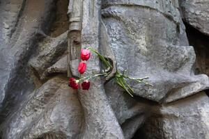 Flowers and a rifle - a monument to those who died in World War II photo