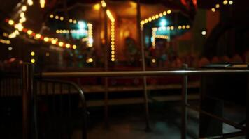 Abandoned amusement park at night with empty carousel and dim lights video