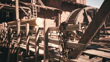 Old wooden structure with chains and logs at a rustic lumber mill video