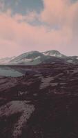View of a landscape of a Norwegian fjord with a snowy mountain and rocks video