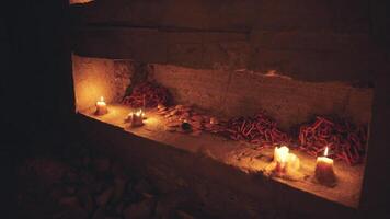 Candlelit altar with offerings during a spiritual ritual in a dark setting video