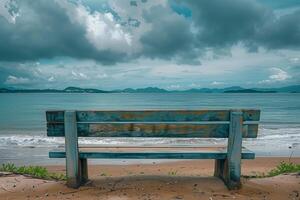 A bench sitting on a beach with a view of the ocean photo