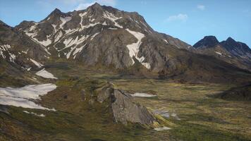 A mountain range with snow on the top of it video