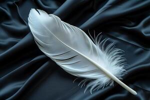 White feather on satin background photo