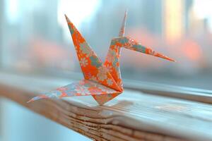 A paper crane sitting on a window ledge photo