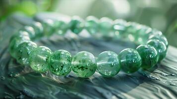 A green bracelet with jade beads on it photo