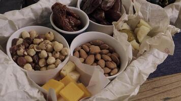 An assortment of nuts and cheeses beautifully presented in a rustic style for any occasion. Media video