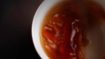 Carefully pouring rich syrup into a pristine white bowl, creating an inviting visual delight. Media video