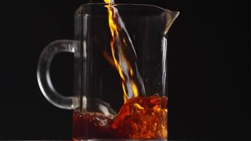 Pouring a Refreshing Beverage into a Stylish Glass Pitcher for Enjoyment and Presentation. Media video