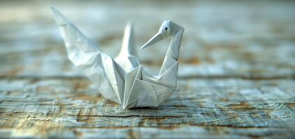 A paper crane is sitting on a wooden surface photo