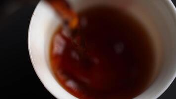 Gently Pouring Hot Tea into a Ceramic Cup and Adding Cream to Create a Delicious Beverage. Media video