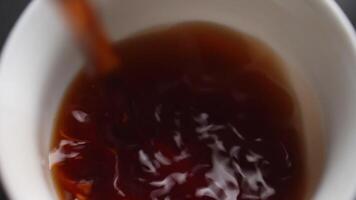 Carefully pouring a delicious beverage into a cup, creating an inviting and cozy atmosphere. Media video