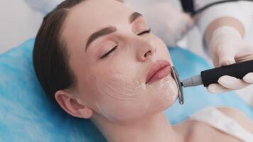 Radio frequency lifting for woman close-up. Dermatologist is doing radio frequency RF skin tightening. RF facelift firms and lifts sagging skin. Procedures for skin elasticity and rejuvenation. Ads video