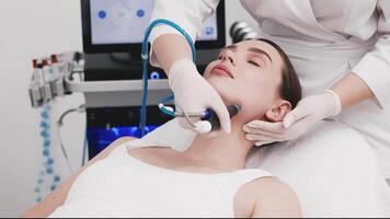 Professional cosmetology. Smart skilled cosmetologist using a modern device while doing hydrafacial procedure. Ideal for promoting luxury beauty services and enhancing your brand image video