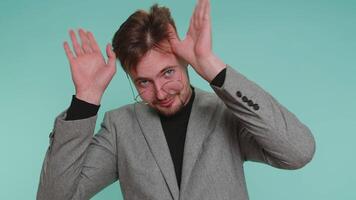 Funny joyful man making playful silly facial expressions, grimacing, fooling around showing tongue video