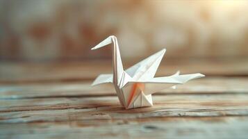 A paper crane sitting on a wooden table photo