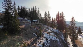 Modern cabin on a hillside with panoramic mountain views, peaceful retreat surrounded by evergreen trees and winter landscape, perfect for solitude seekers video