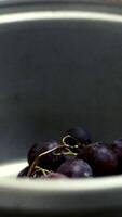 Picking grape into bowl Background video