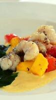 Chef adding pieces of fish and asparagus mango isolated video