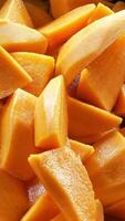 close up to fresh pieces of cut and riped mango in pot ready to cook dessert for tropical snack dried mango paste or mango smoothie video