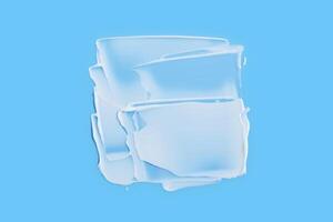 A smear of white cream in the shape of a square on a blue background. photo