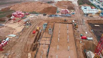 Aerial view of construction site with cranes, foundations and building materials. Residential building under construction. Progress of new development in small town video