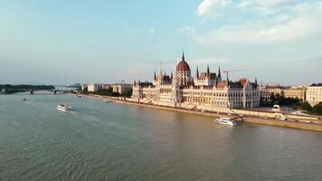 Hungarian Parliament Building in Budapest at sunset with reflection in Danube River, aerial view. Neo Gothic architecture and famous landmark of Hungary video