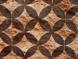 A brown and black patterned tile with a design video