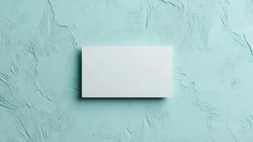 Top view template for business card. Mockup white card on texture background in mint pastel color. photo