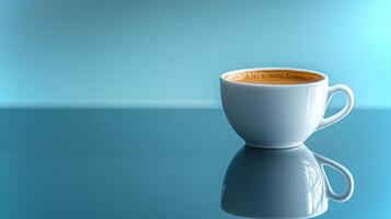 A pure white coffee cup filled with brown coffee stands alone on a glossy surface, reflecting a calming blue background in a tranquil environment. photo