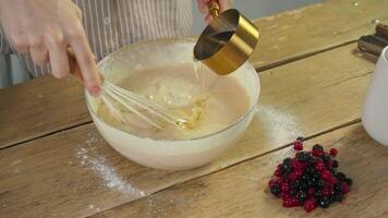 Pastry chef adds liquid baking powder to dough and egg mixture in order to create more viscous texture when baking pies or pancakes. video