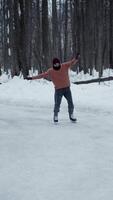 Young man is skating on ice, his movements are unsteady, and he loses his balance, falling heavily onto slippery surface. He may have suffered a fracture or other injury. video