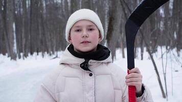 A young hockey player is preparing for a practice session. He stands up and throws a hockey puck into the air with his hand. Slow motion. Portrait. video