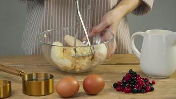 In process of preparing sweet baked goods, the pastry chef transforms a banana into a uniformed banana puree using a masher. video