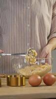 In the process of making sweet pastries, the pastry chef turns the mango into a homogeneous puree using a masher. Vertical. video