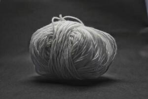 ball roll of white thread for sewing and knitting photo