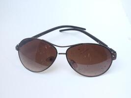 sunglasses with round brown lenses isolated on white background photo