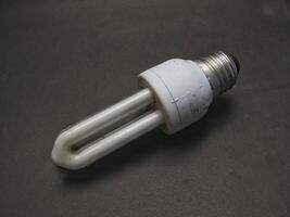 white light bulb isolated on black background, electrical equipment, lighting tools photo