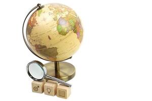 A Globe with symbol icon education on wooden block cube and Magnifying glass. Learning, study, knowledge and education concept. photo