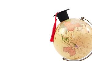 A Graduation cap placed on globe. It is the concept of education, knowledge, learning and successful. photo