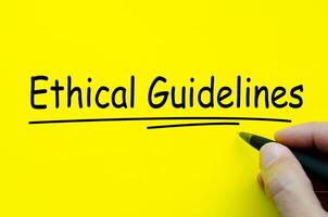 Hand written text about Ethical Guidelines on yellow notepad photo