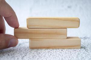 Hand pulling wooden block with customizable space for text. Copy space concept photo
