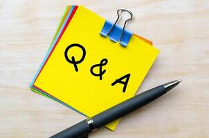 Q and A text on yellow notepad. Question and Answer concept photo