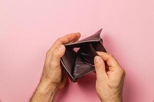 Desperate search for cash in an empty wallet during financial crisis photo